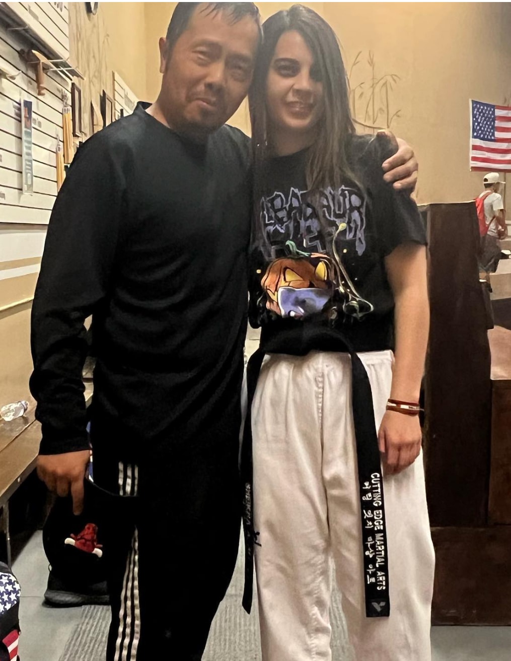 Martial arts instructor posing with a student