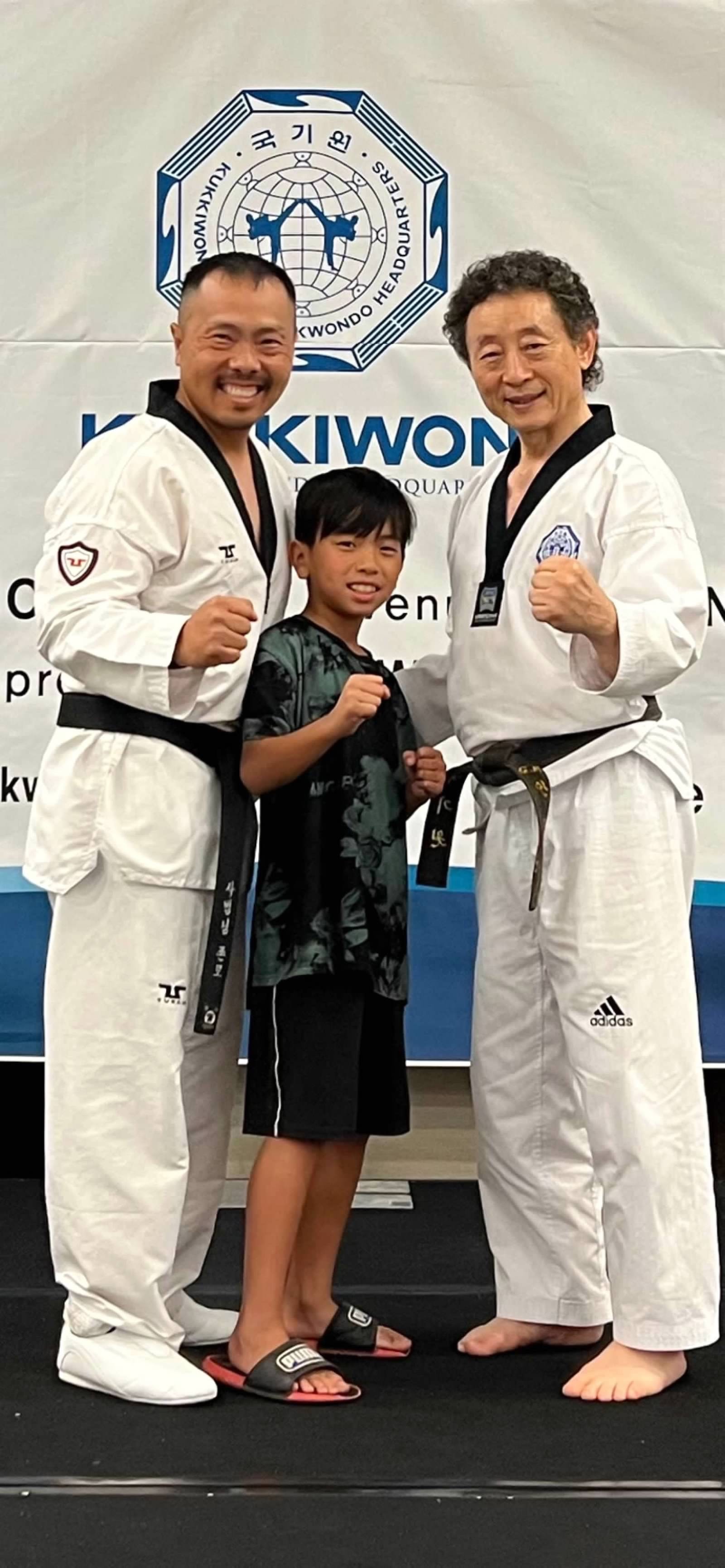 Taekwondo practitioners posing at Kukkiwon headquarters
