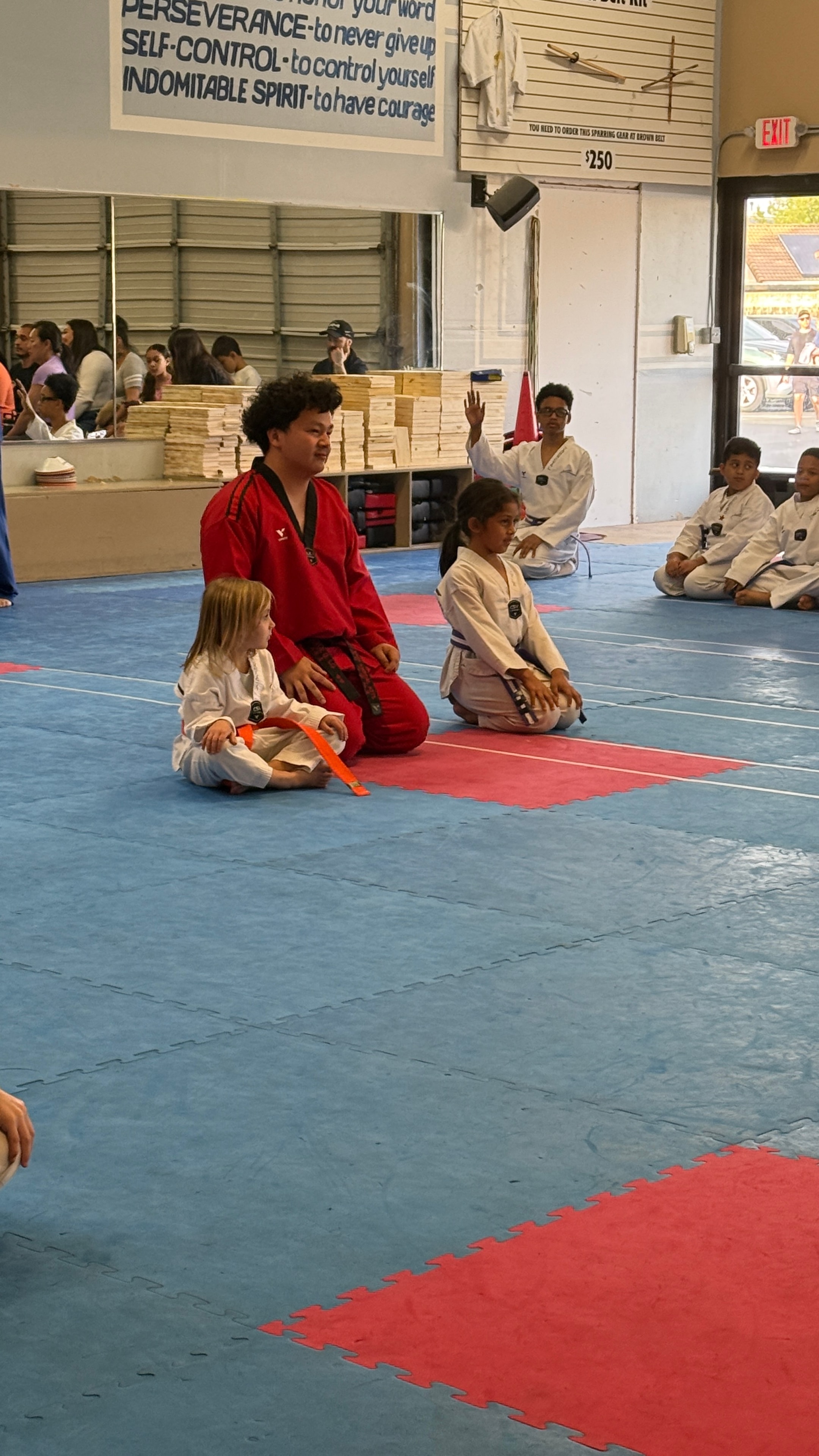Young martial arts students listening to their instructor