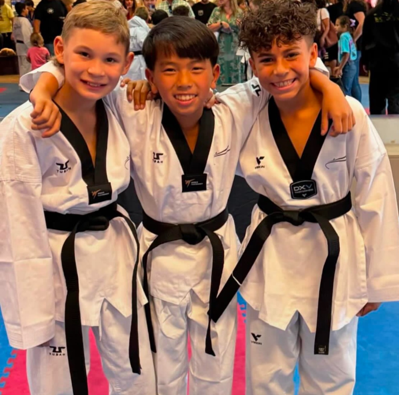 Three young martial artists posing together