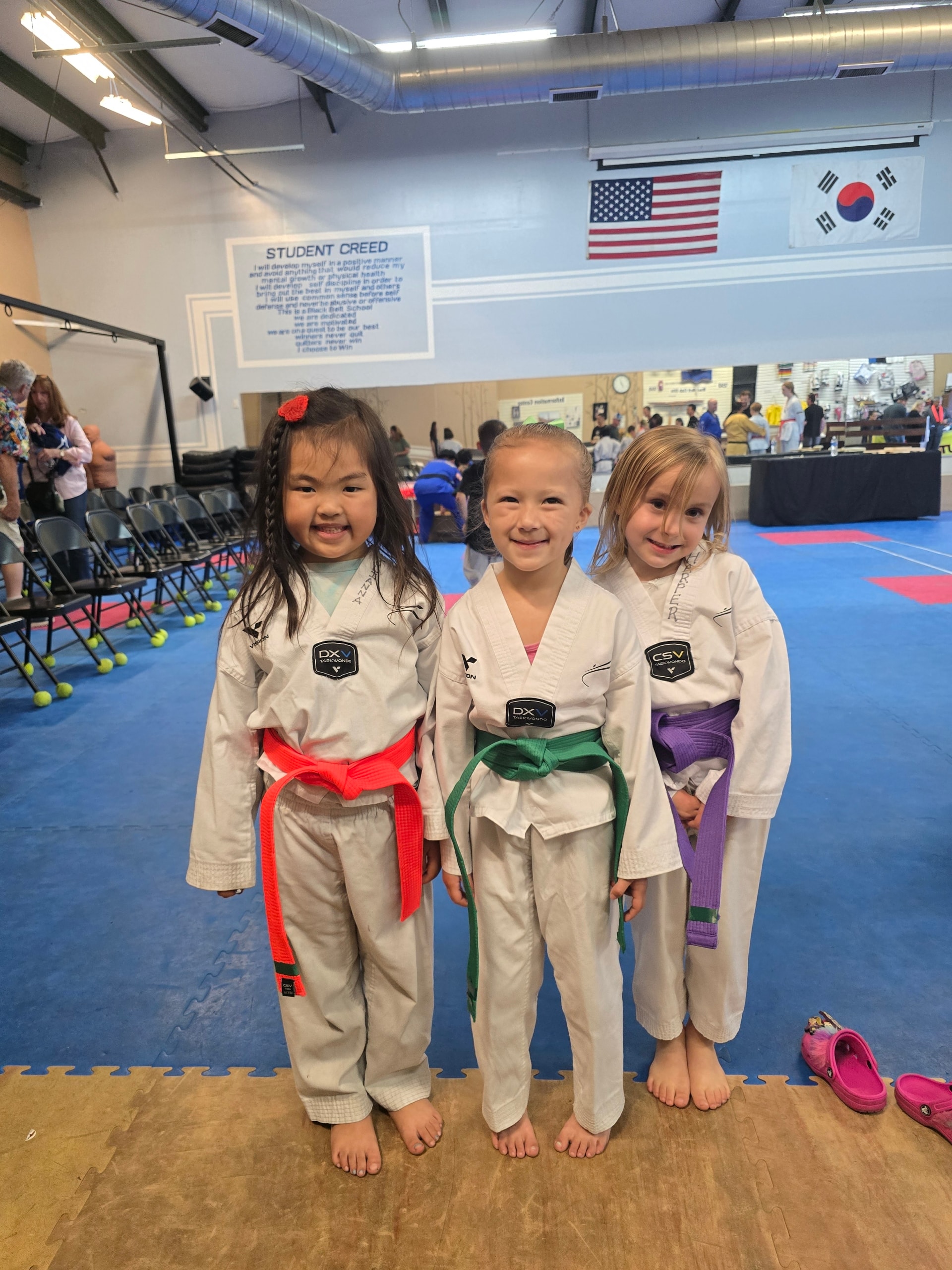 Three young martial arts students in uniforms