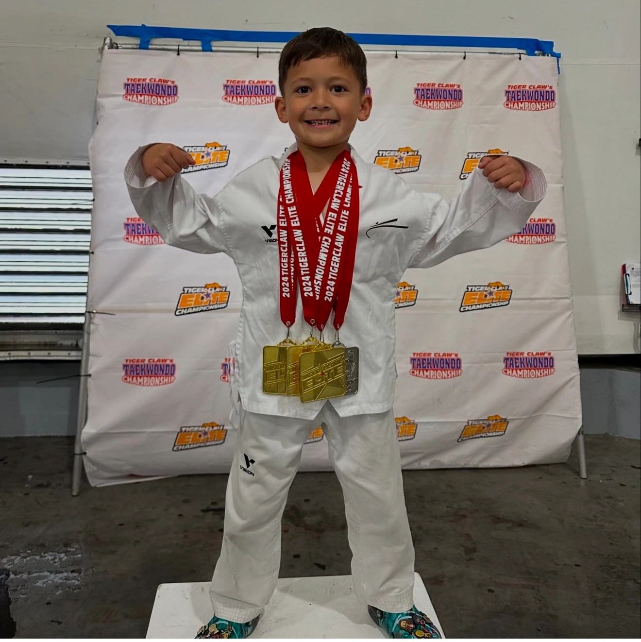 Taekwondo competitor with championship medals